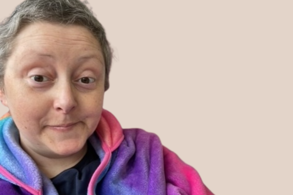 A woman in a colourful jumper taking a selfie