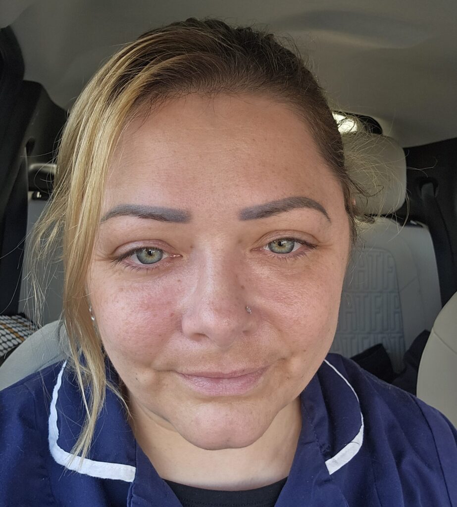 A woman in a blue shirt looks upset post-surgery