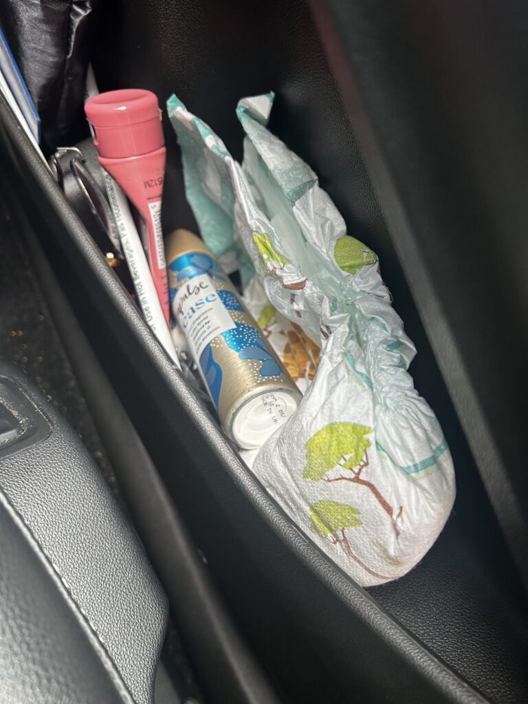 A car door filled with ostomy products and a nappy