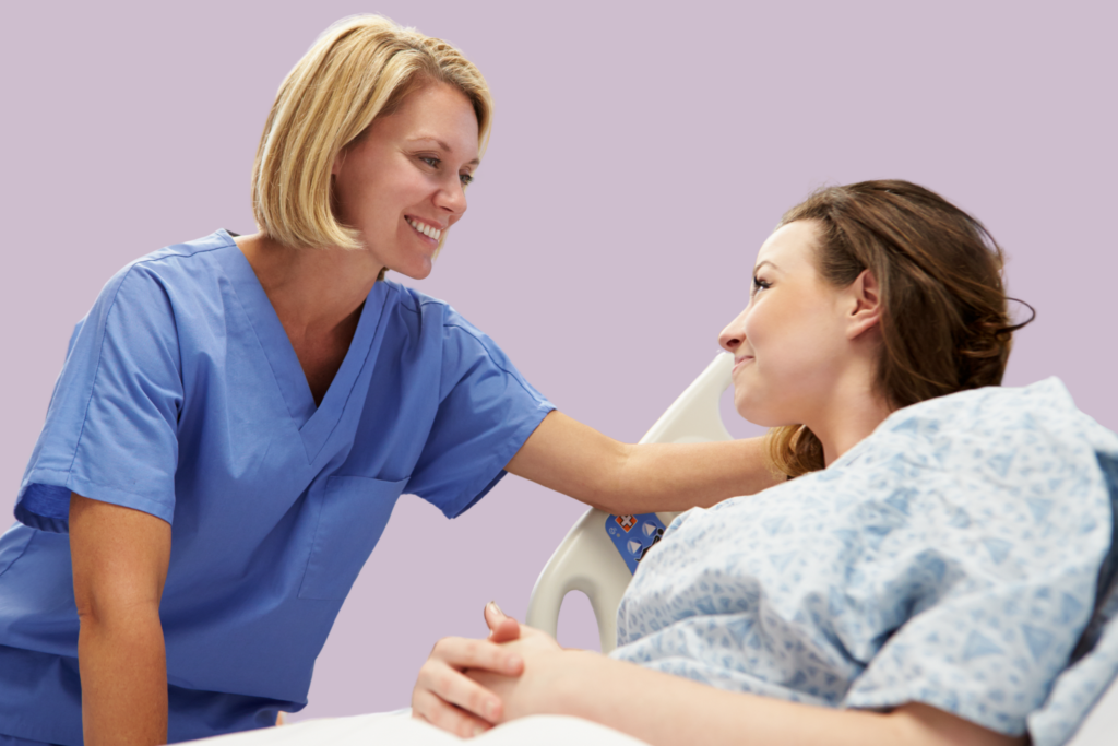 A nurse smiles at her patient, who is lying in a bad, awaiting treatment.